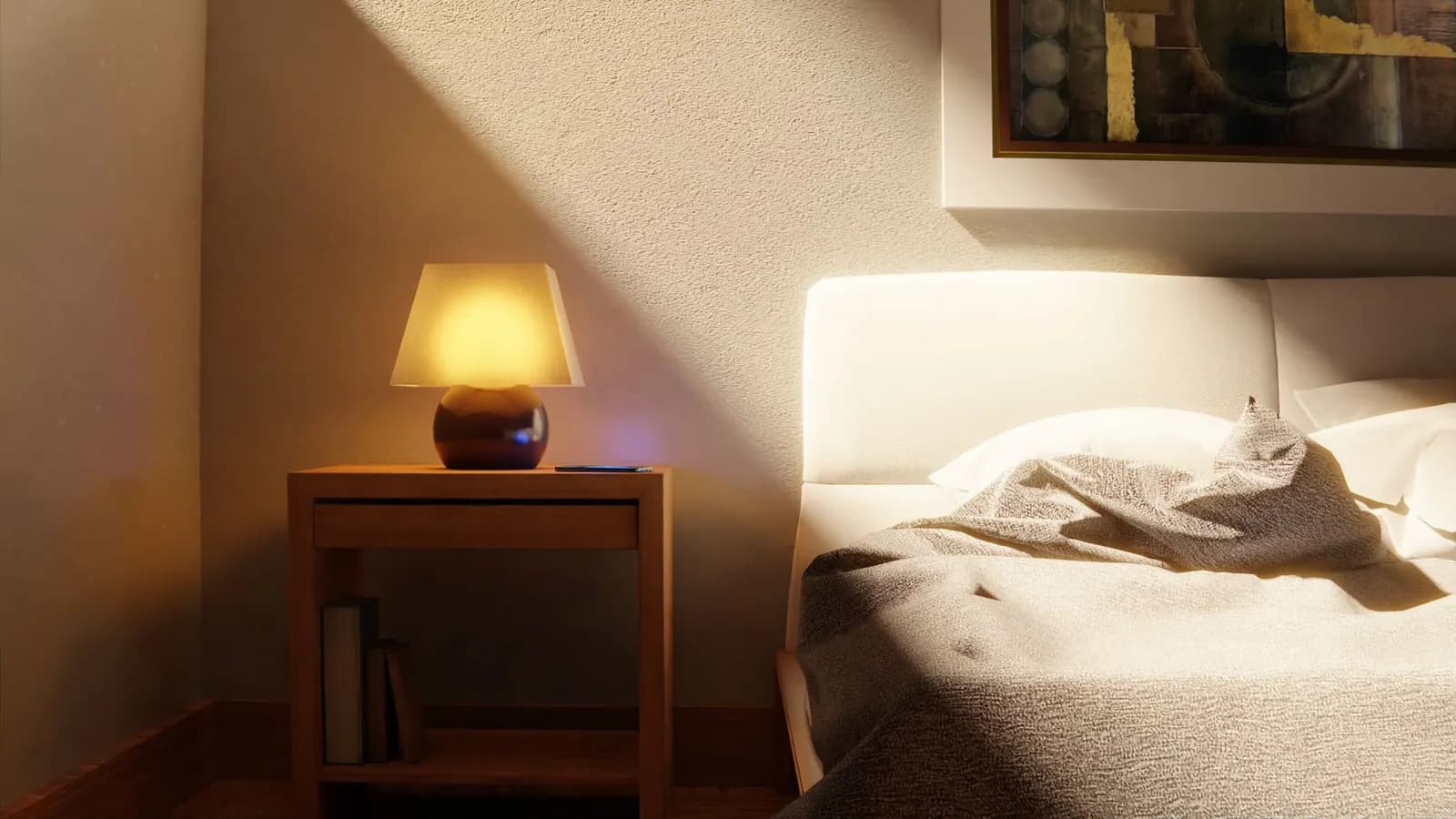 Warm and inviting bedroom interior with a bedside lamp and abstract art.