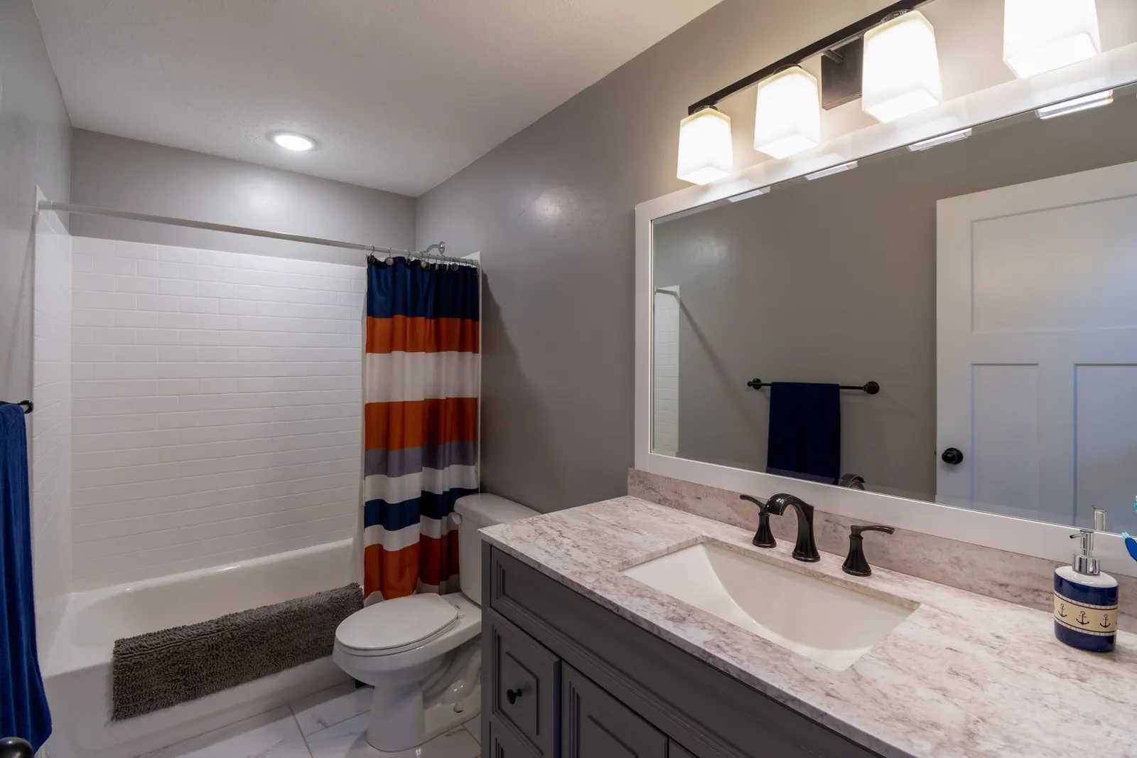 Small white bathroom with a cotton bath mat, a polyester shower curtain and a window