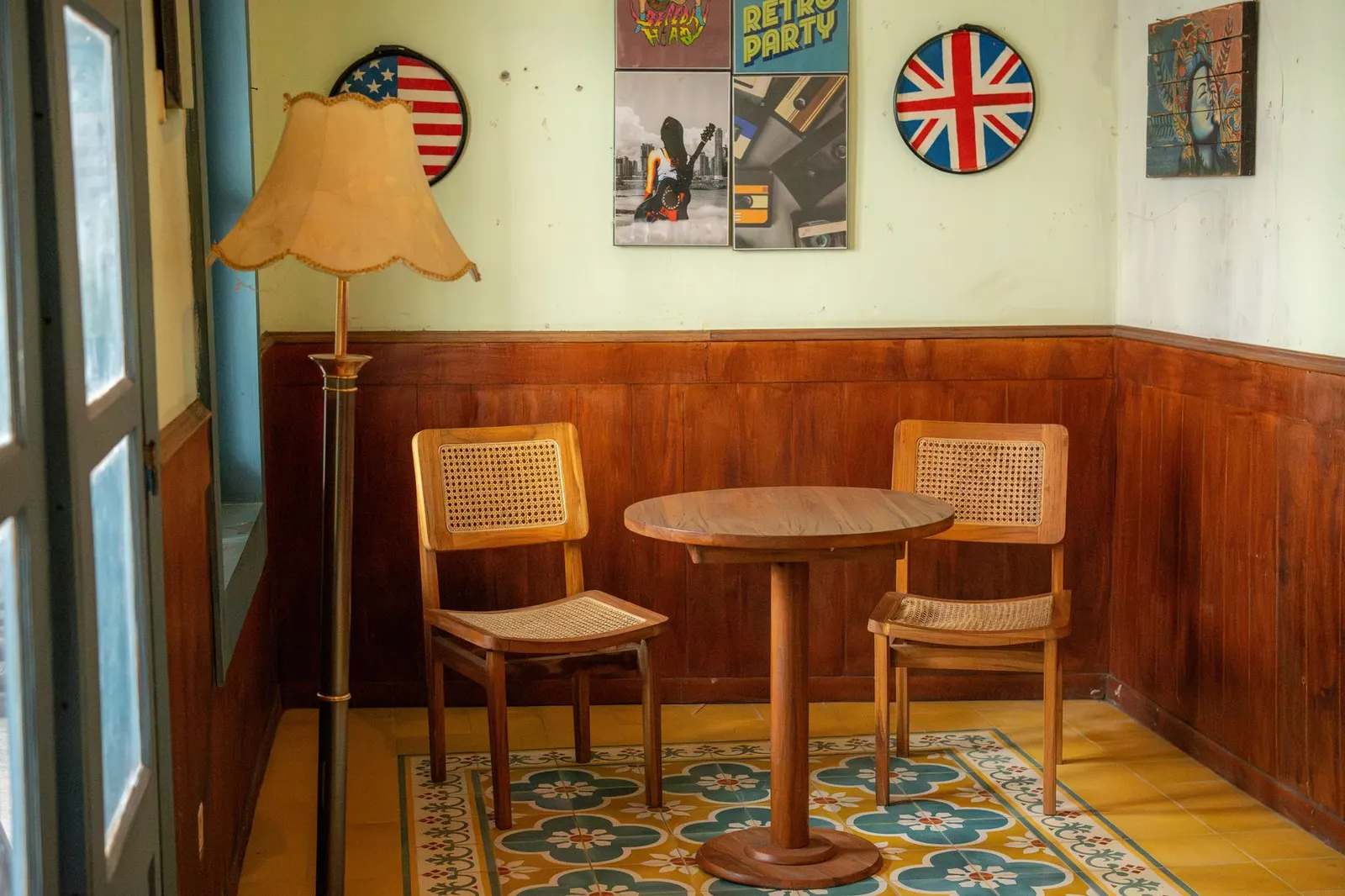Cozy vintage room with wooden chairs, round table, and retro decor, creating a nostalgic ambiance.