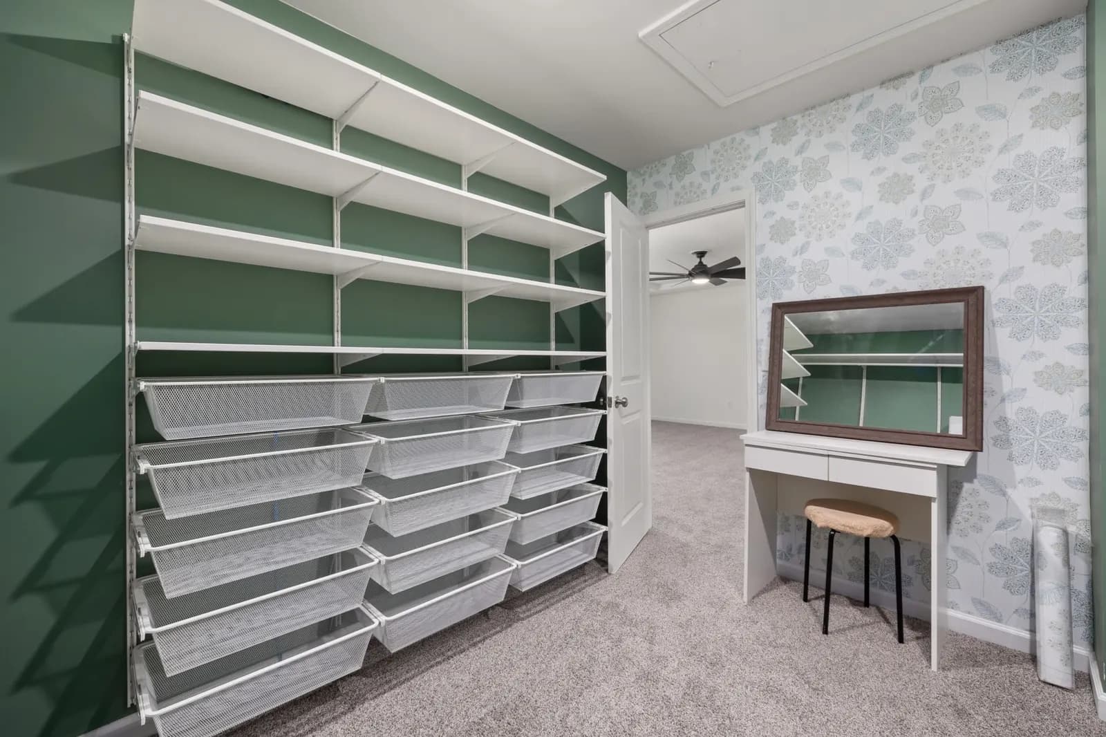 Walk-in closet with shelves of matching white storage bins