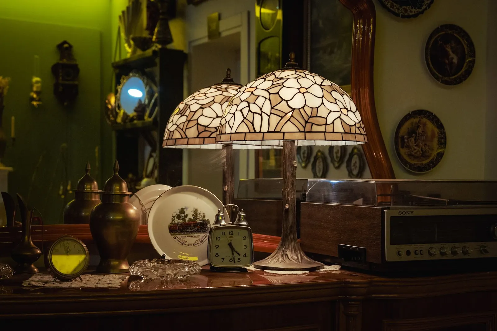 Cozy interior showcasing vintage decor, Tiffany lamp, and retro items in an antique store setting.