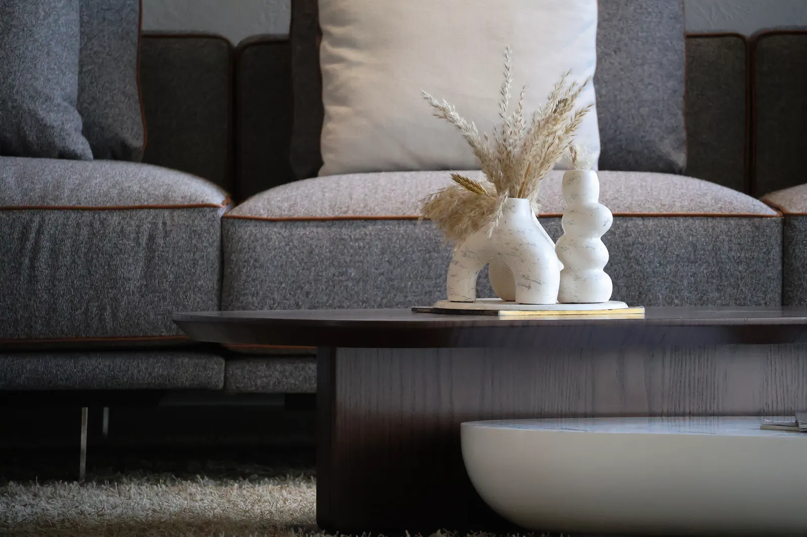 Elegant living room with modern decor featuring stylish vases and a cozy sofa.